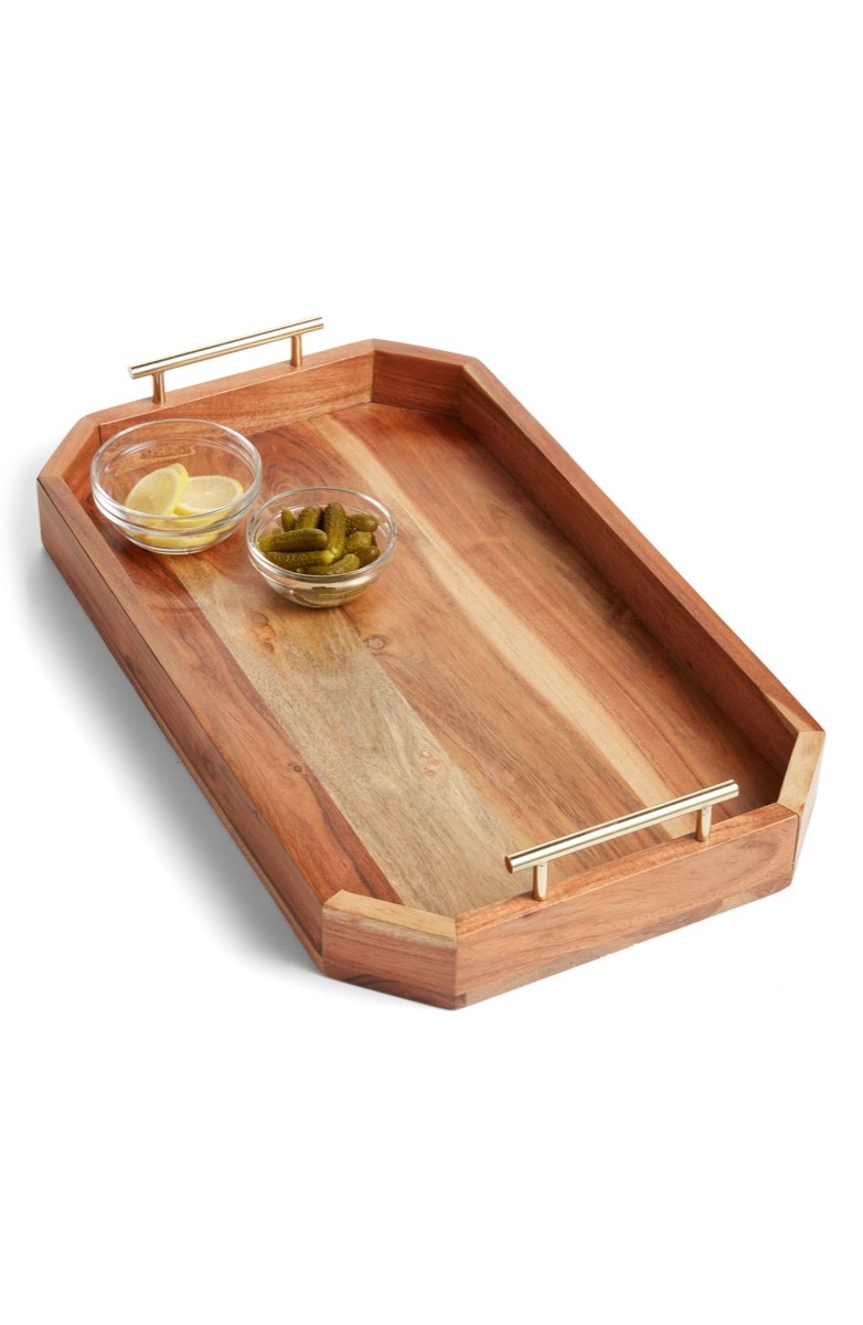 wooden tray with silver handles and two glass ramekins on it