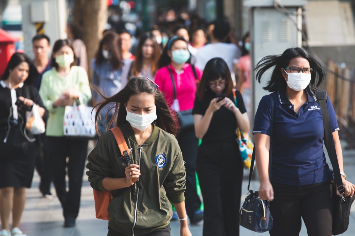 People walking wearing masks