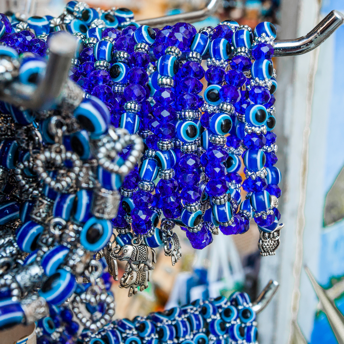 Evil eye bracelets on a rack in a store.