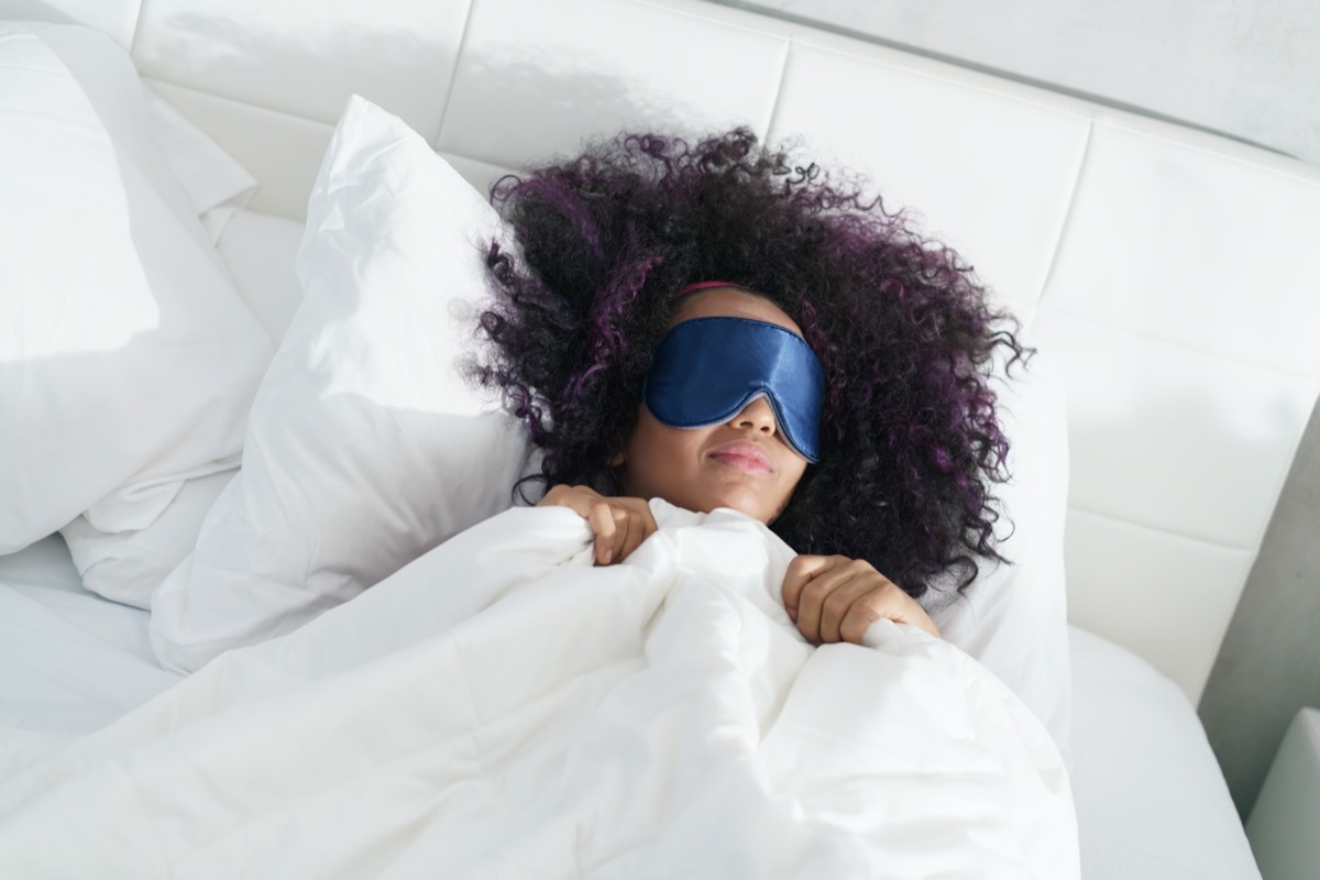 woman sleeping in bed with eye mask