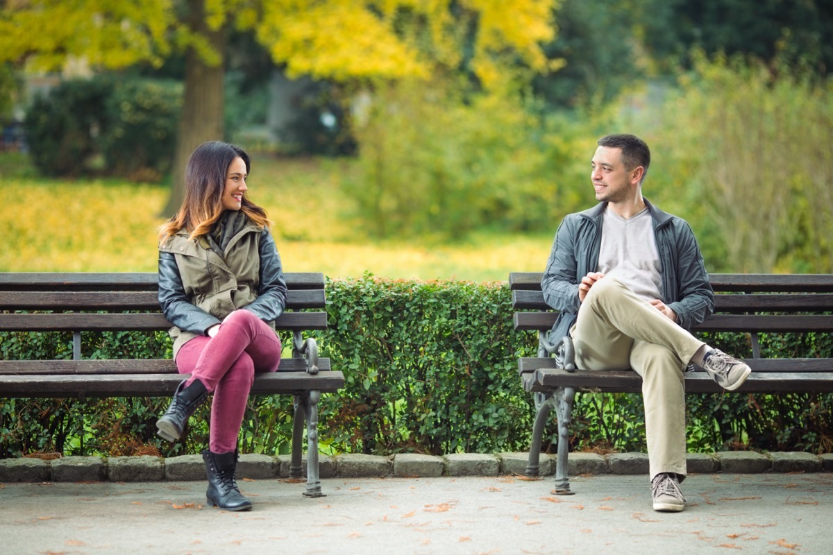 Young man and woman meeting in park