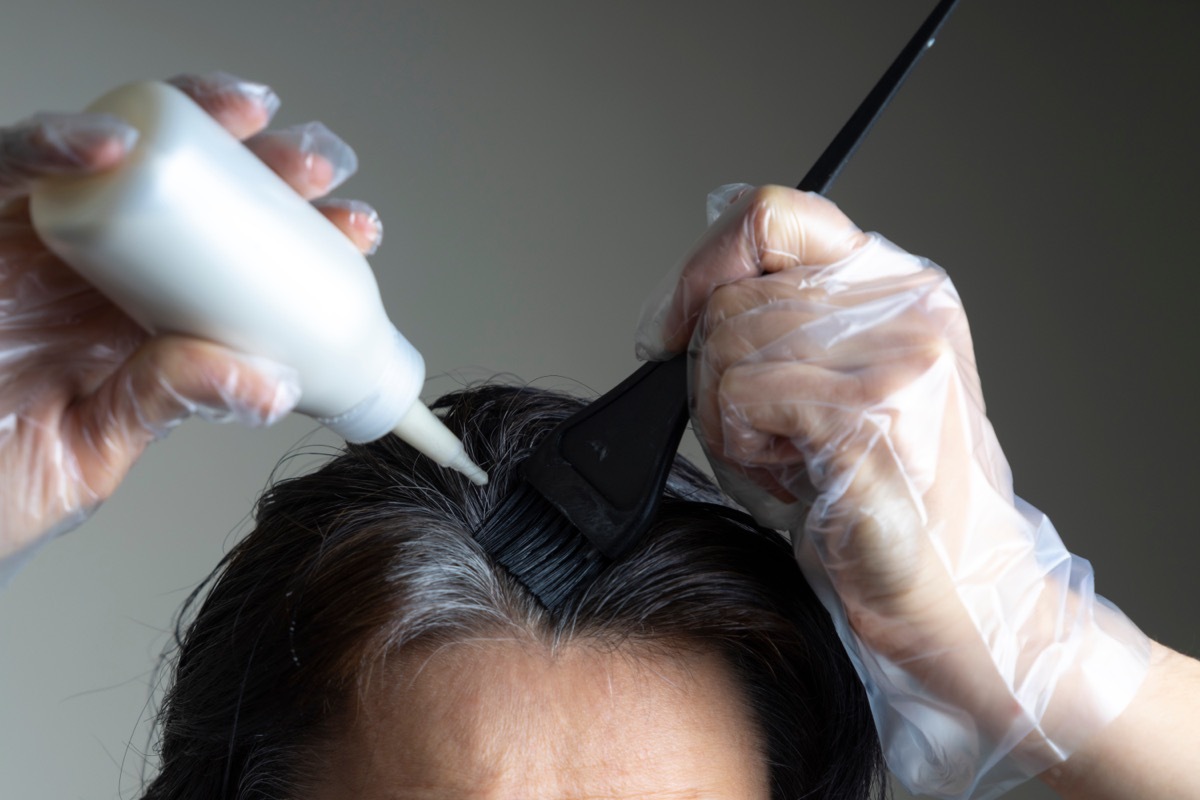 Woman doing her hair at home. 