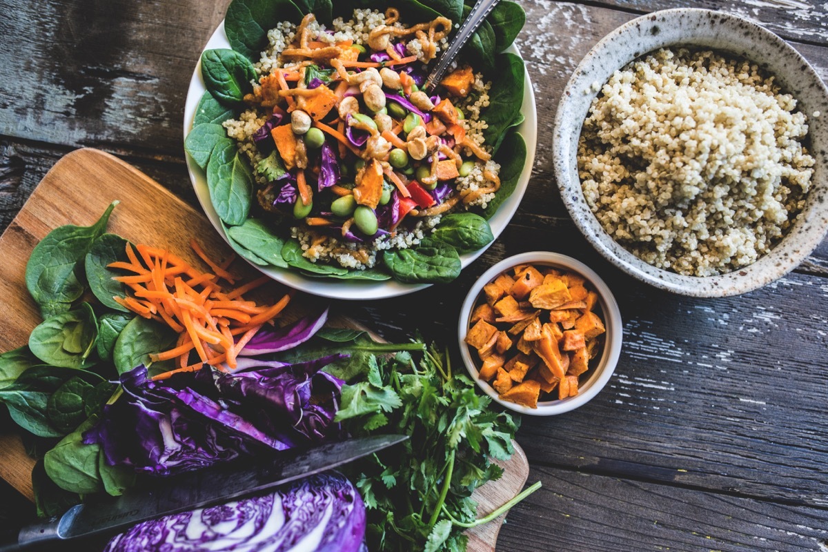 Colorful, rustic plant based meal of vegetables over coconut quinoa