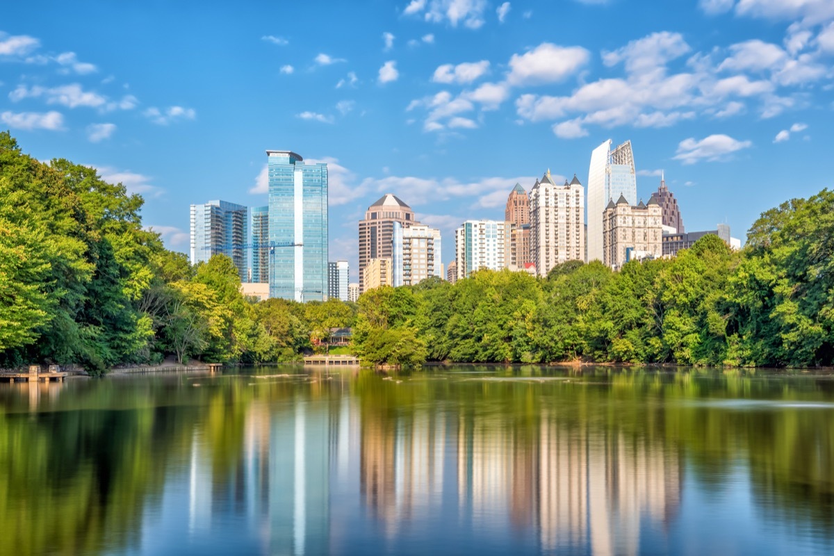 atlanta skyscrapers seen from a park with a body of water affordable vacations