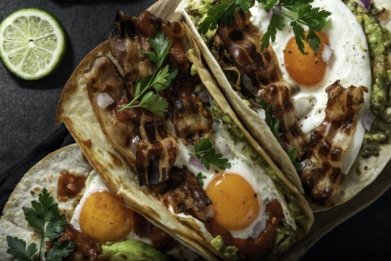 Breakfast tacos with eggs, avocado and bacon