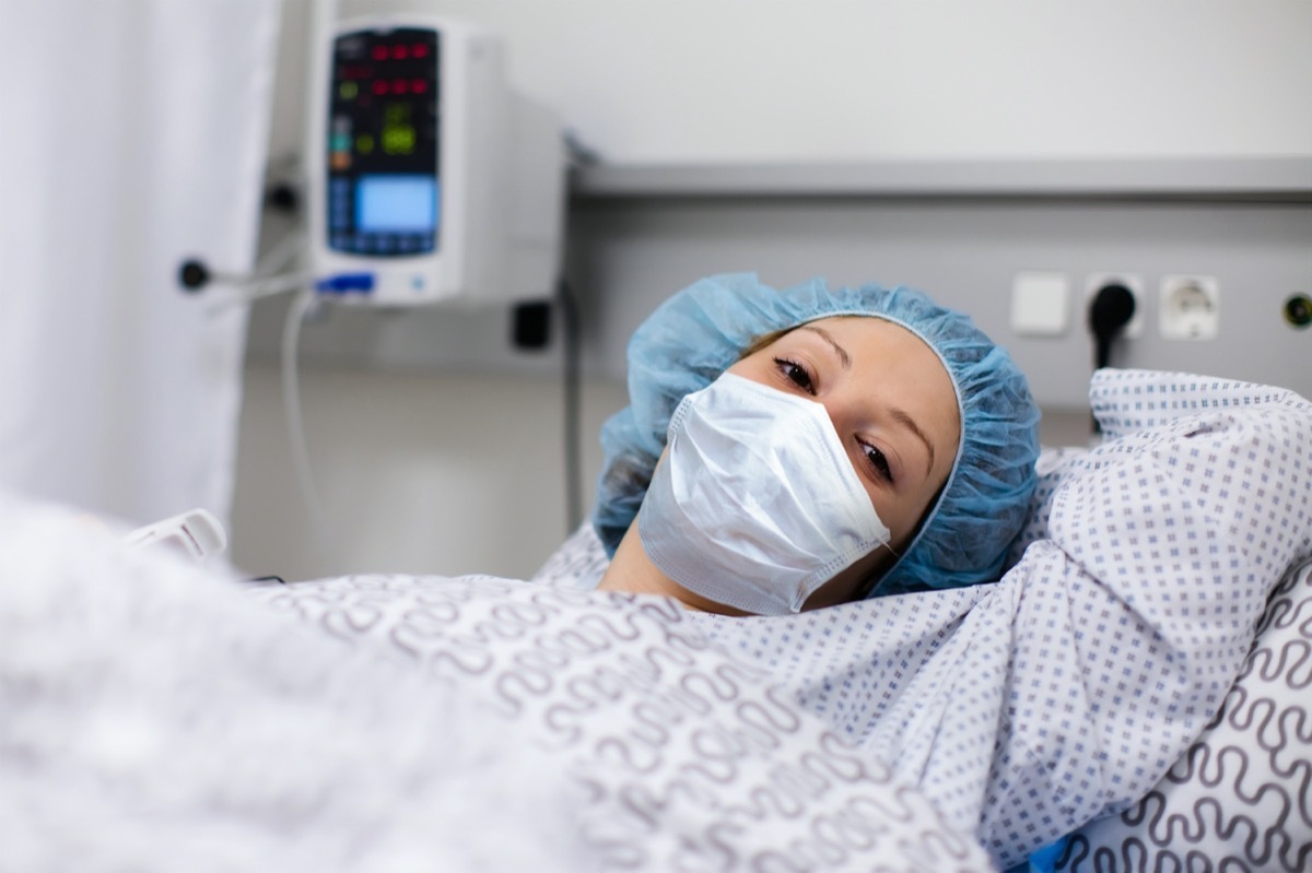 woman wearing face mask in clinic ward recovering from coronavirus disease.