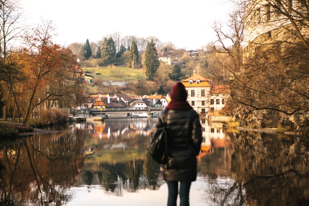 Solo travel woman looking at lake countryside