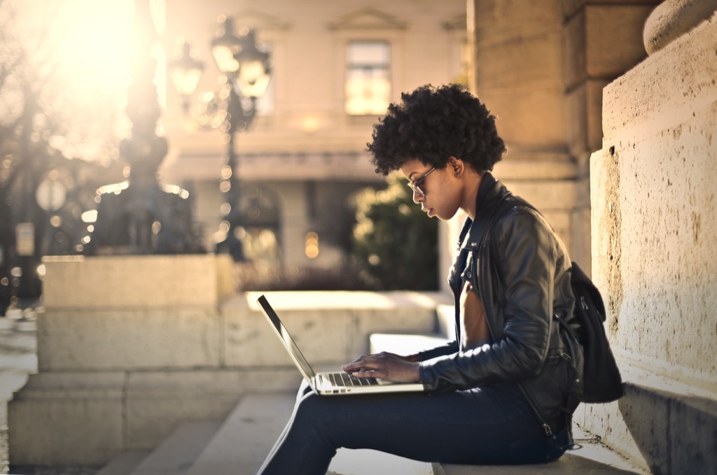 a woman responding to email on a laptop computer