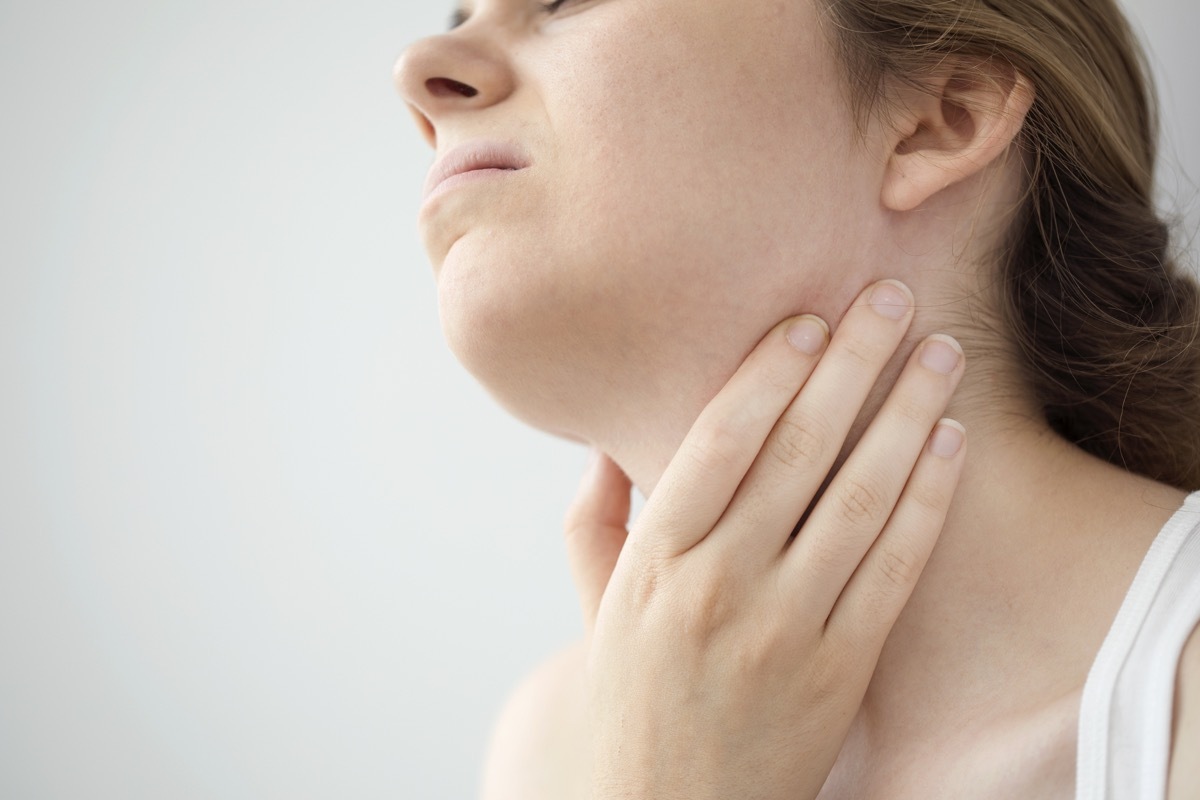 Woman feeling pain in the throat from swollen lymph nodes