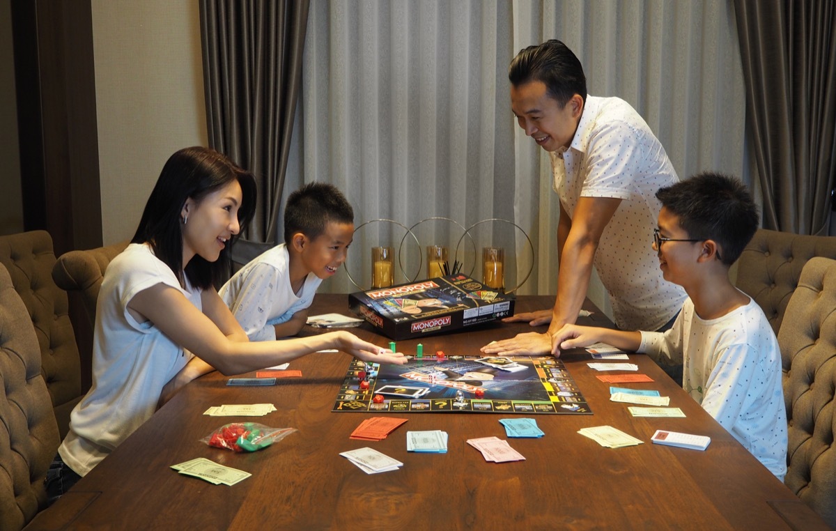 Family playing monopoly for family game night