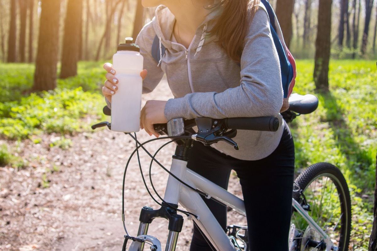 woman taking a rest after riding her bike