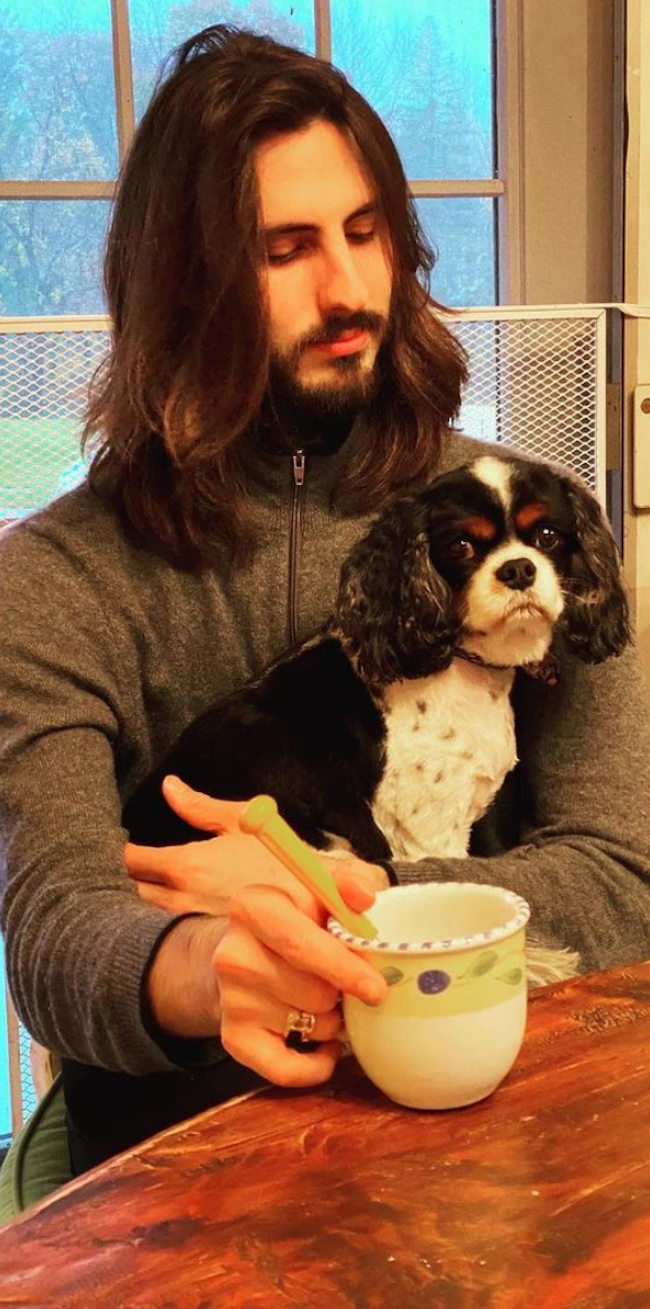 Jonathan Otcasek holding a dog.