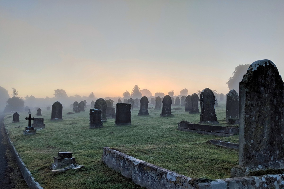 Misty cemetery at sunrise