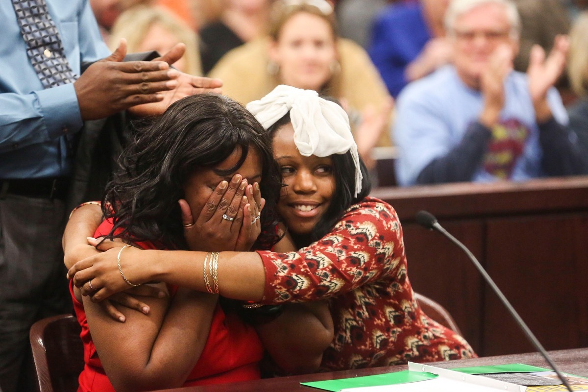 EAXRMM Nov. 21, 2014 - Tampa, Florida, U.S. - EVE EDELHEIT | Times.Valeishia Mays cries as her newly adopted daughter, Audris, 17, hugs her while her adoption is finalized during the Hillsborough National Adoption Day Celebration at the George Edgecomb Courthouse in Tampa on Friday, November 21, 2014. The family lives in Clearwater. (Credit Image: © Eve Edelheit/Tampa Bay Times/ZUMA Wire)