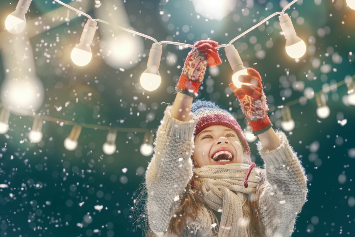 Happy child playing on a snowy winter walk