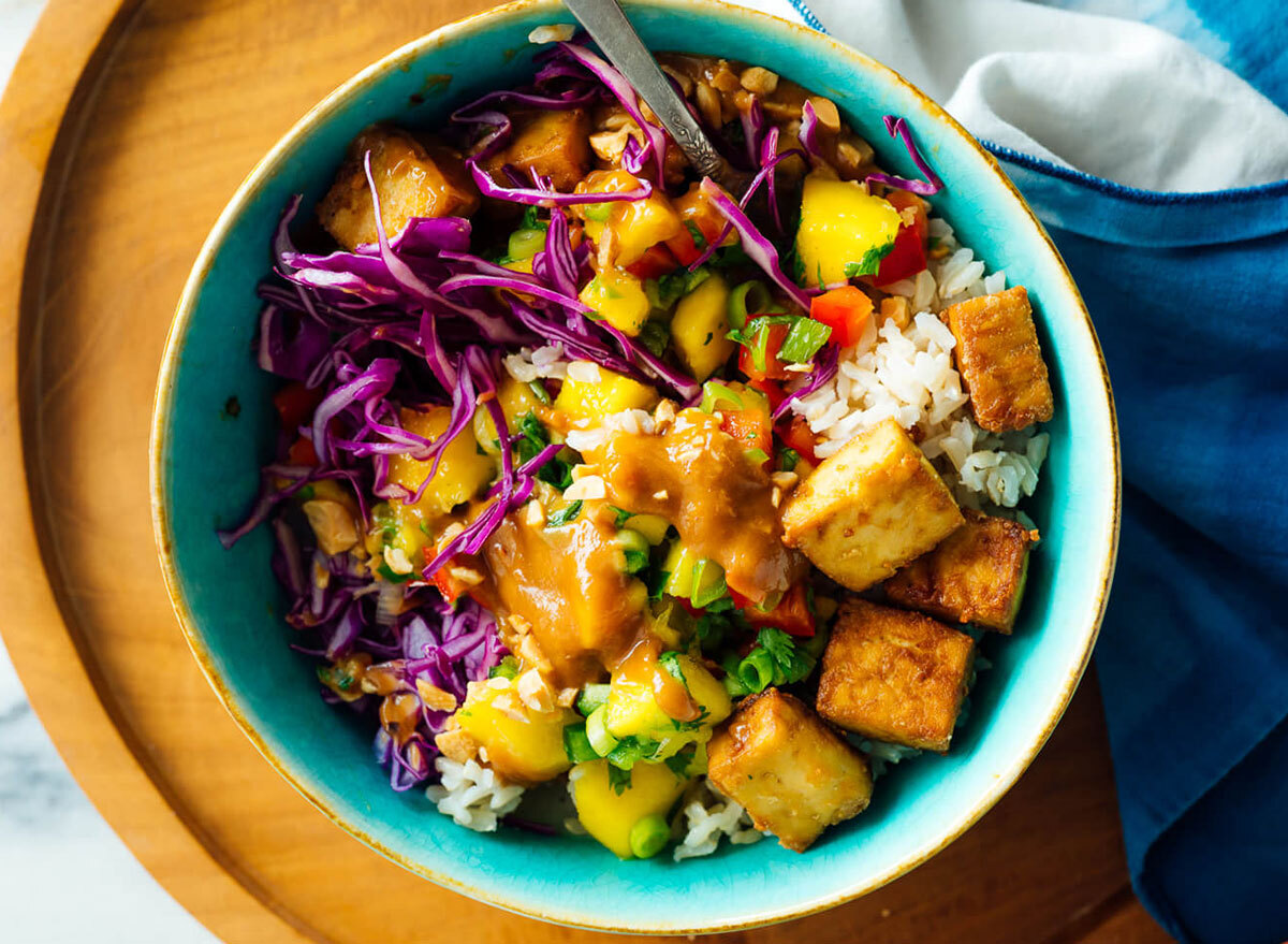 mango burrito bowl on wooden serving board