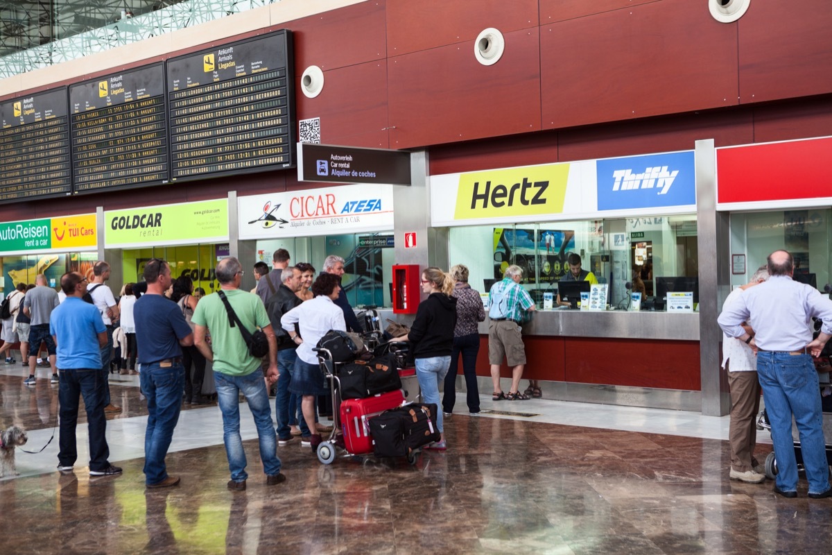 car rental stands at a busy airport