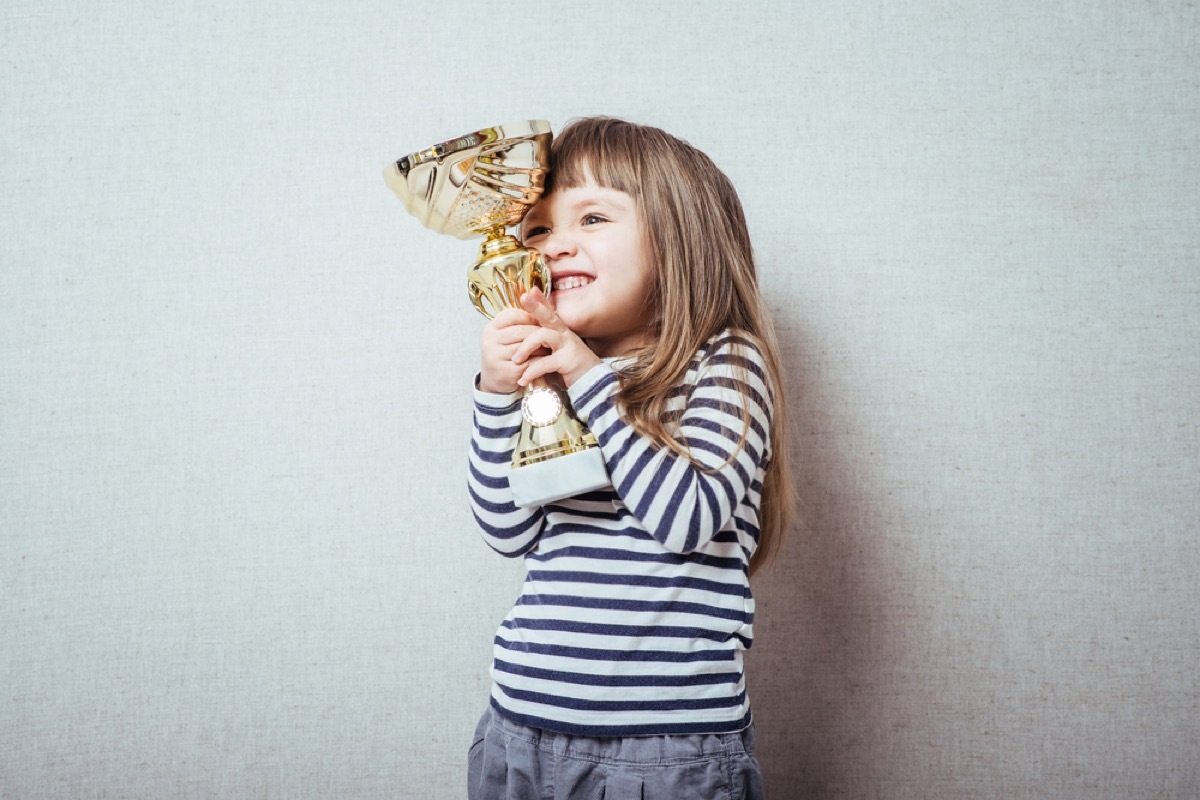 little girl holding trophy, bad parenting