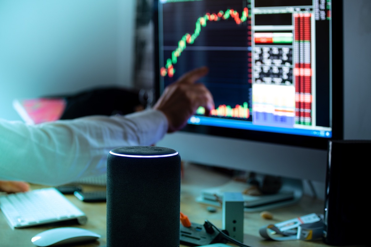 Rome, Italy, june 2020. Personal assistant Alexa in office business room, artificial intelligence help for trading online and live stock quotes news