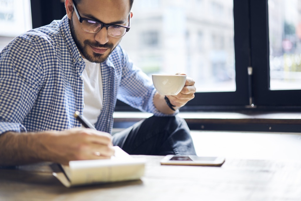 man taking notes ways to get a promotion after 40