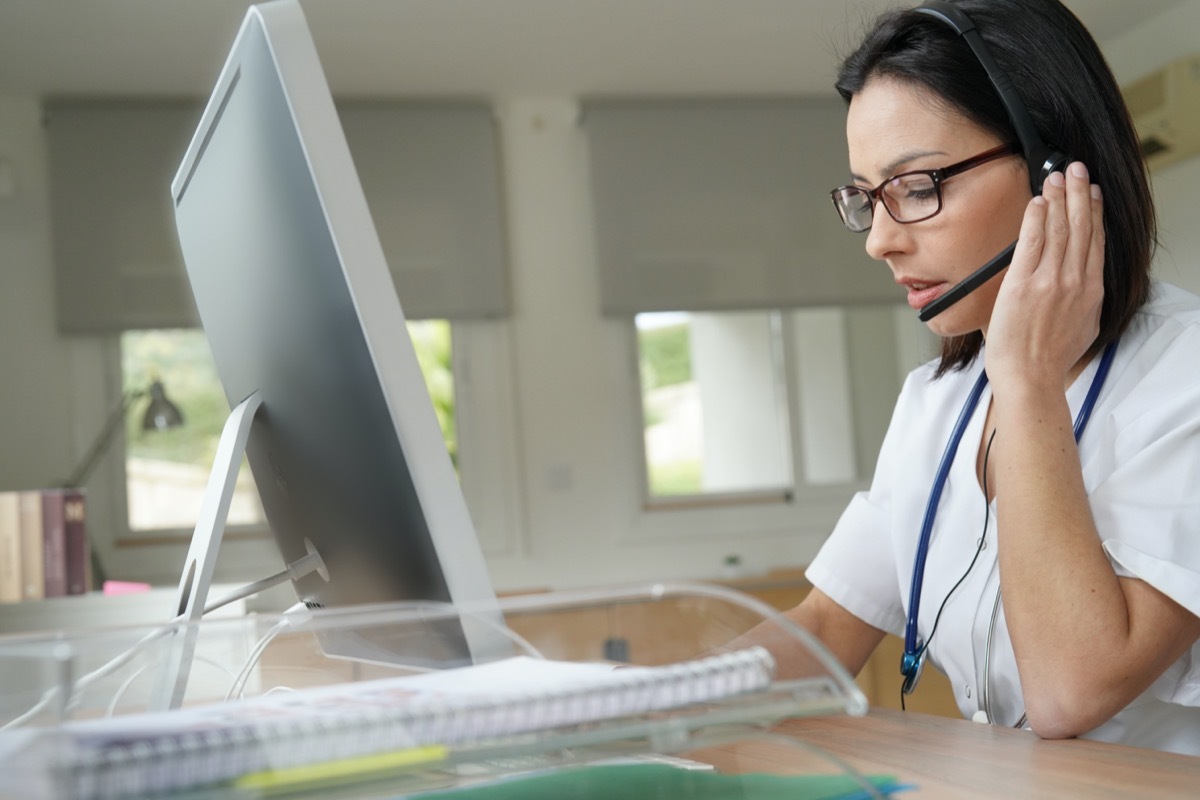 Medical secretary typing report on desktop computer