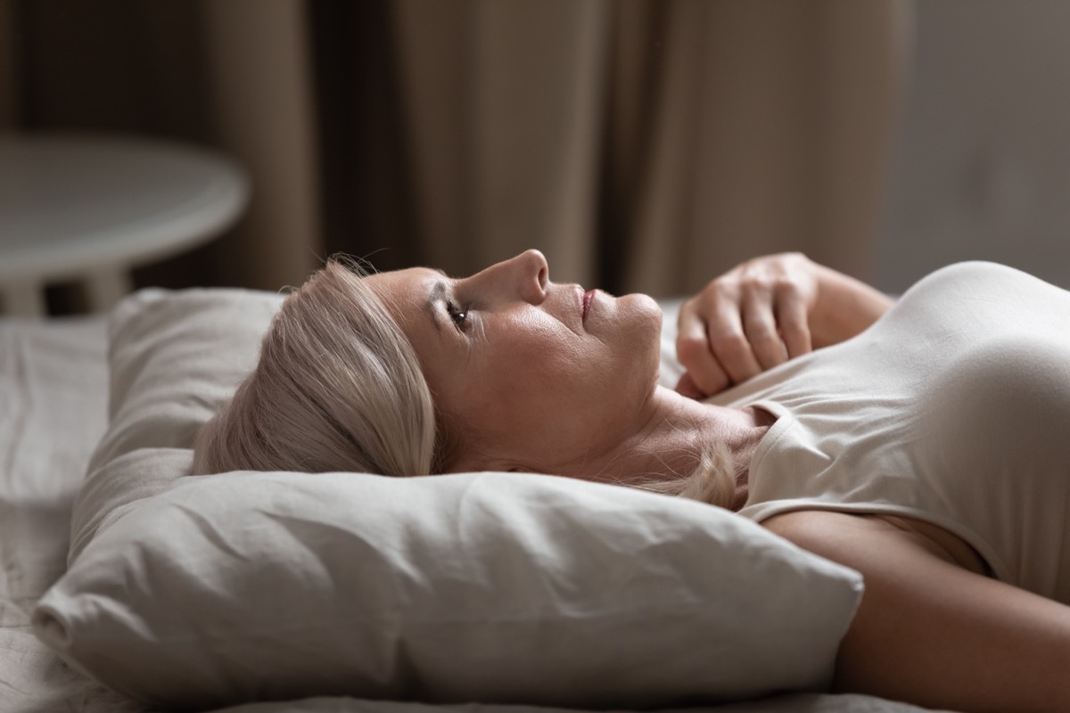 older woman lying in bed 