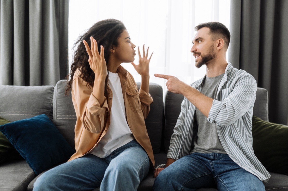 A couple fights on their couch.