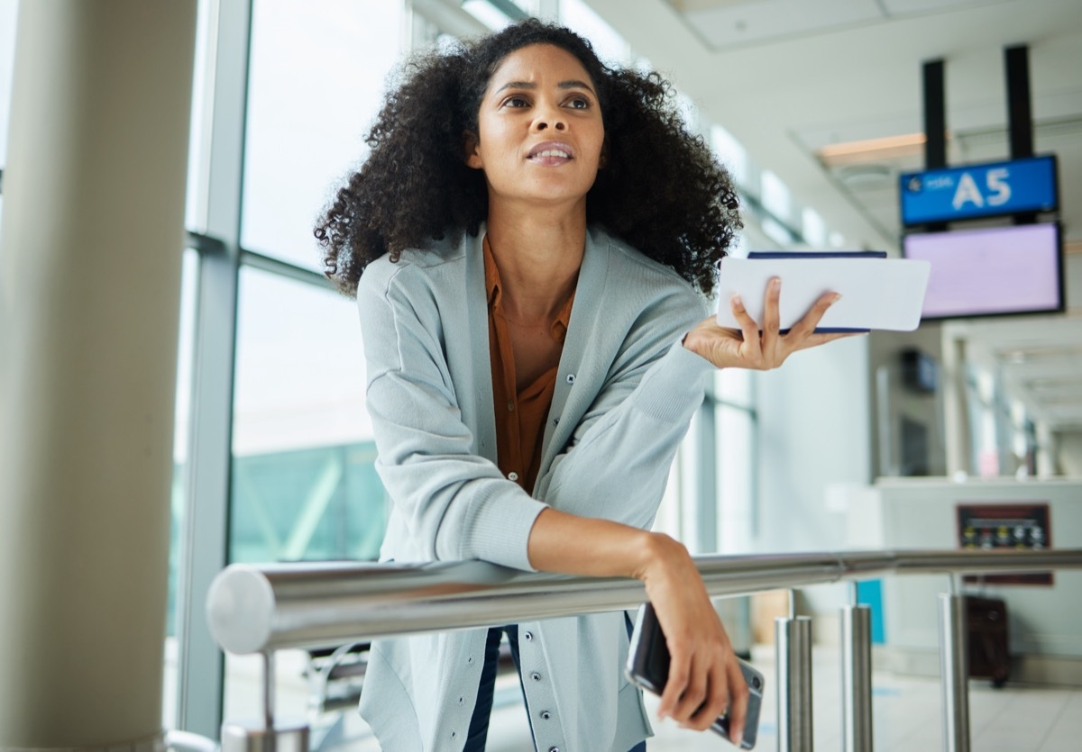 woman hearing that her flight is delayed