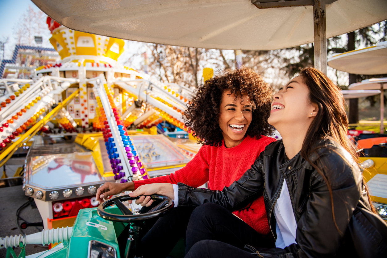 Two friends riding amusement park ride