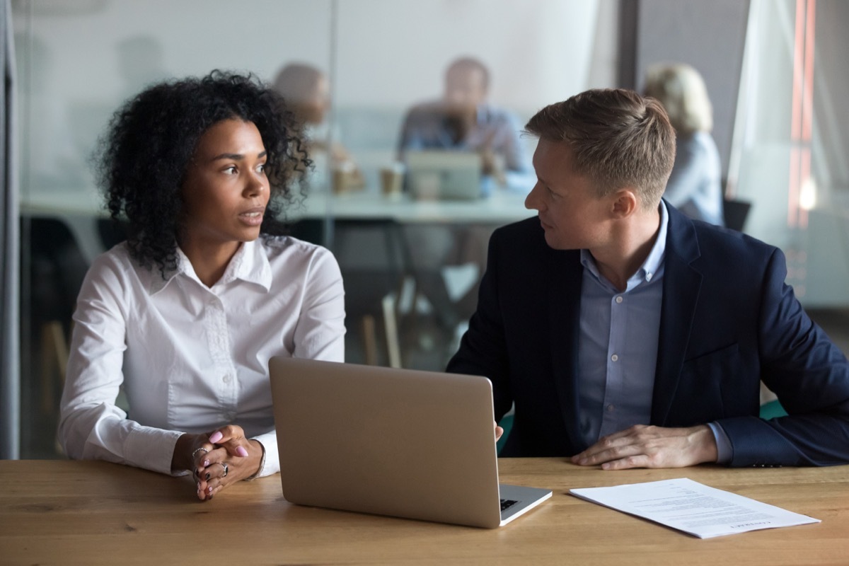 Confident businessman mentor giving instructions to trainee at workplace, helping new employee with online project, checking results, ceo manager holding job interview 