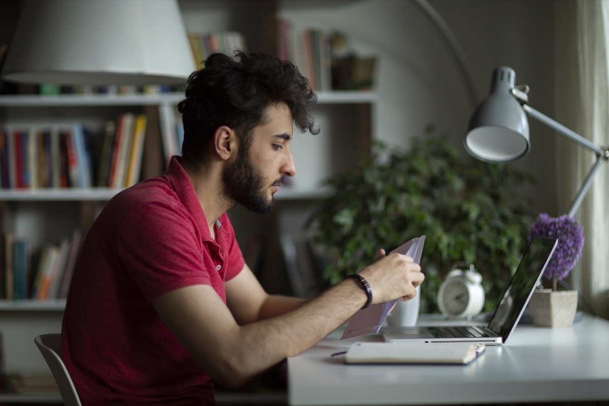 Male student open postal letter from college committee