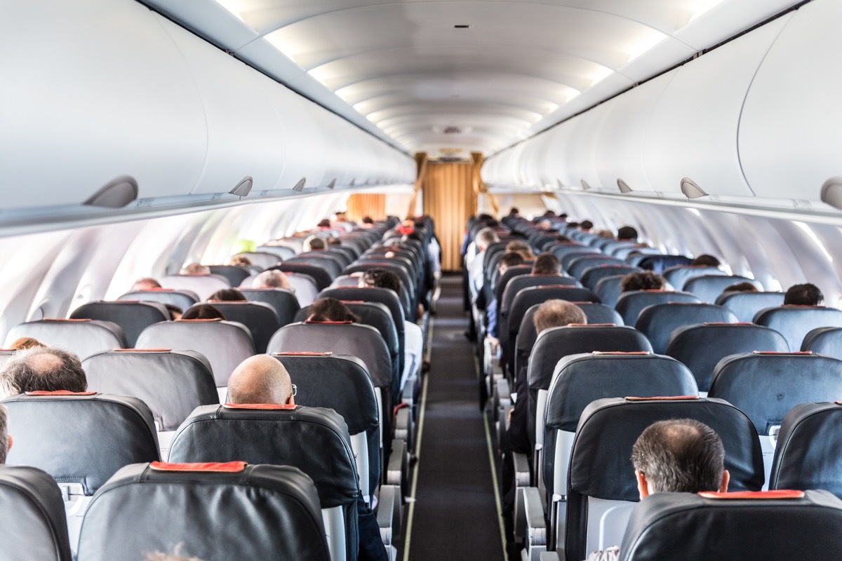 people in a crowded airplane cabin