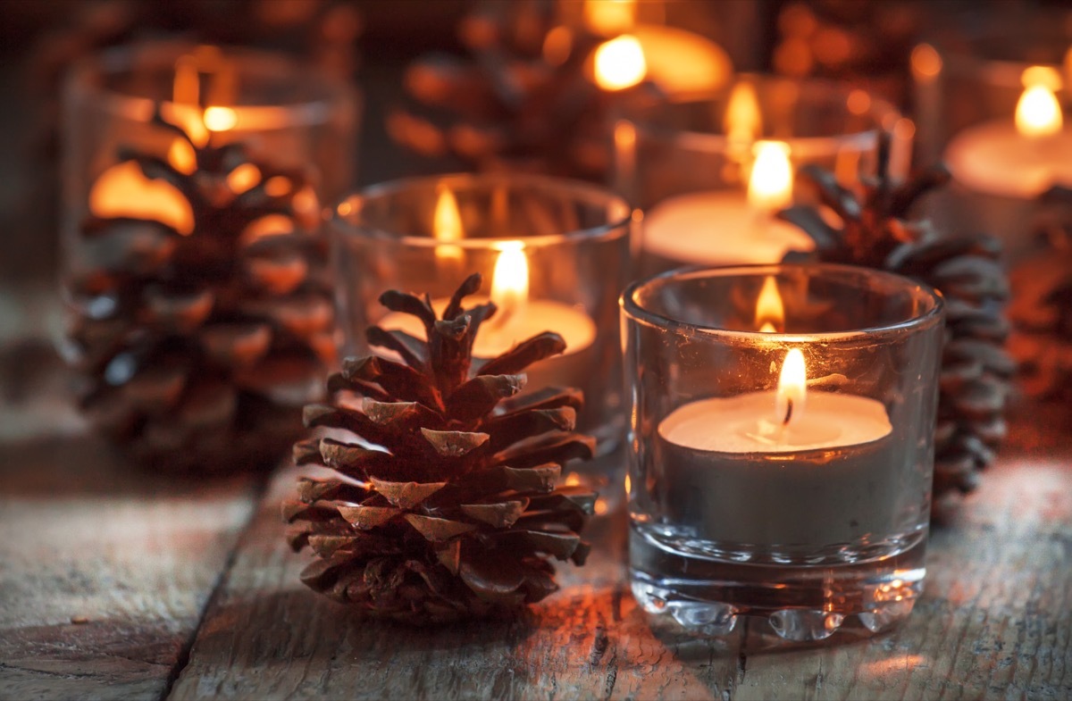 christmas candles surrounded by pine cones