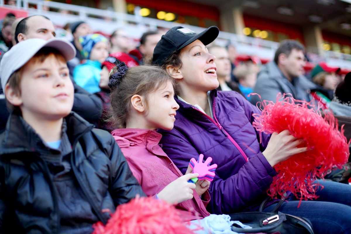 Mother with daughter and son among fans at stadium