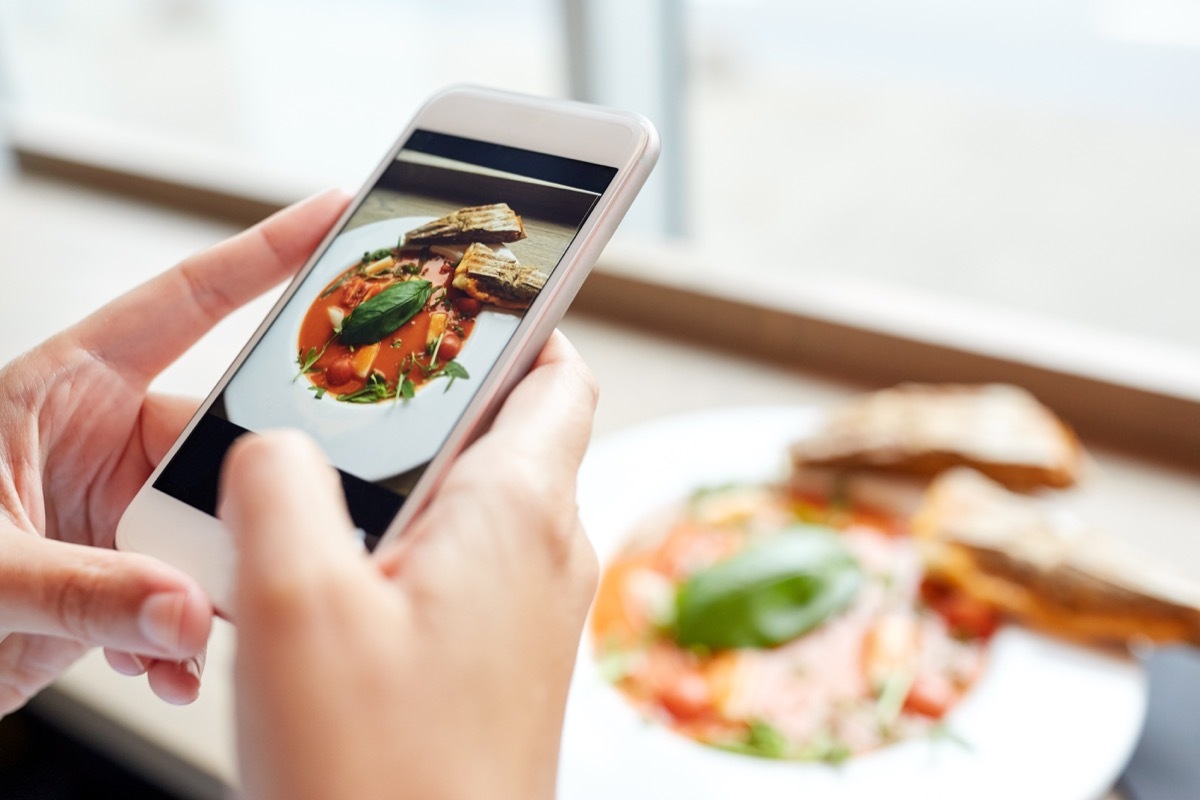 Person taking a picture of their food before eating