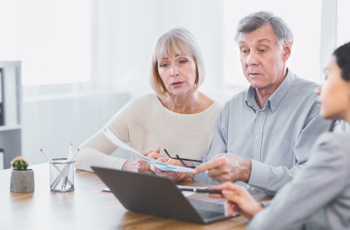 older couple going over interest rates with lender