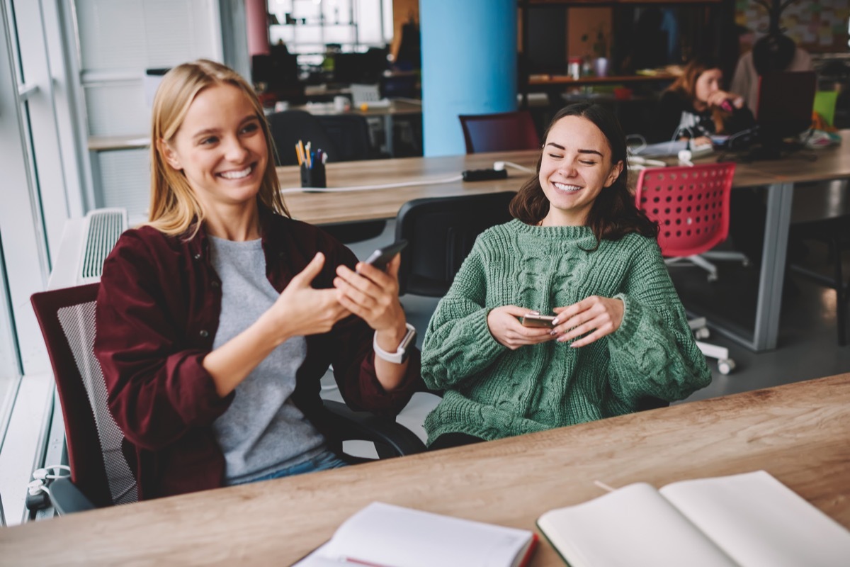 two women laughing in their co-working space