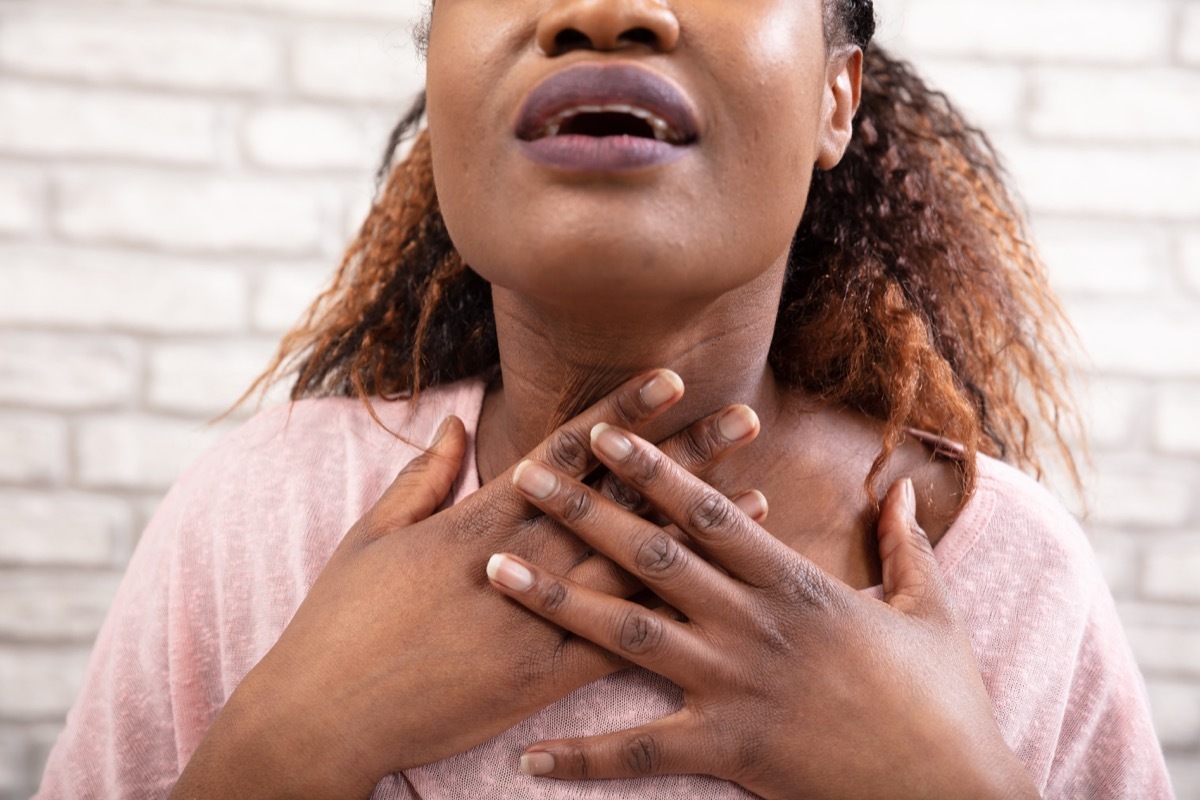 Woman's Hand Touching Her Sore Throat