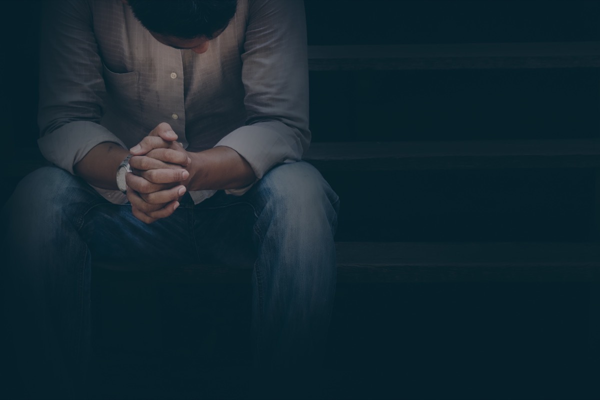 miserable man sitting on stairs