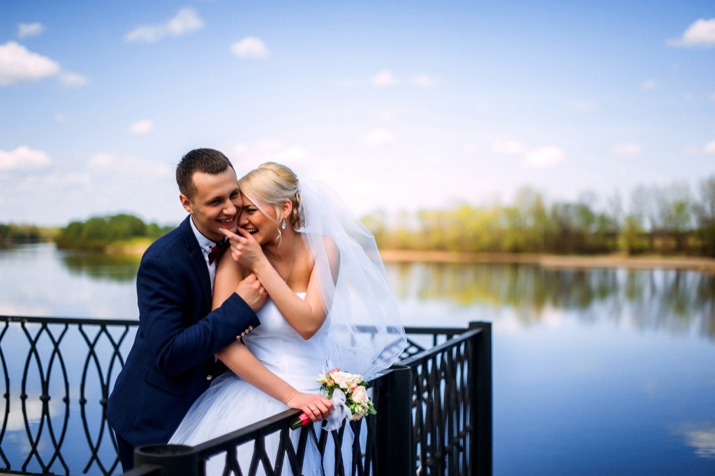 bride and groom by lake this is the age most people get married in every US state