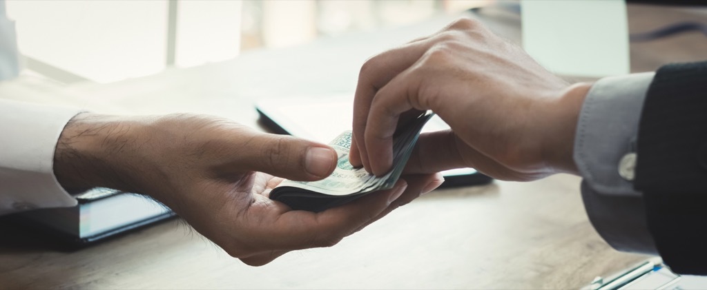 woman handing man money, prepare children for divorce