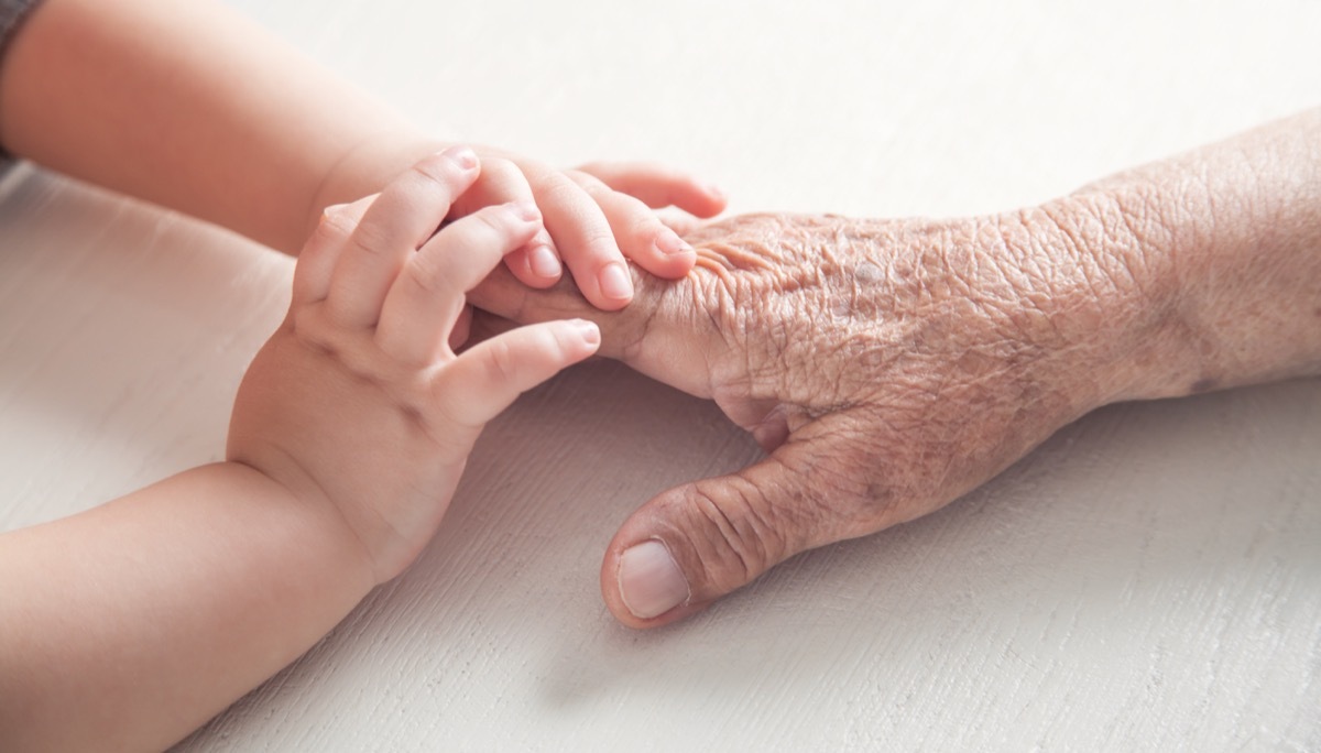 elderly hands with baby hands