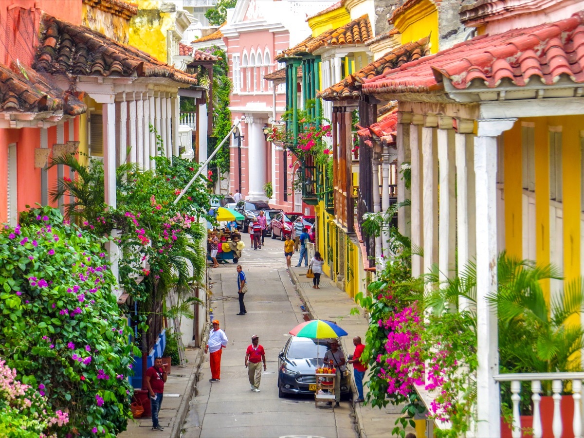 Street in walled city in Cartagena Colombia with people walking