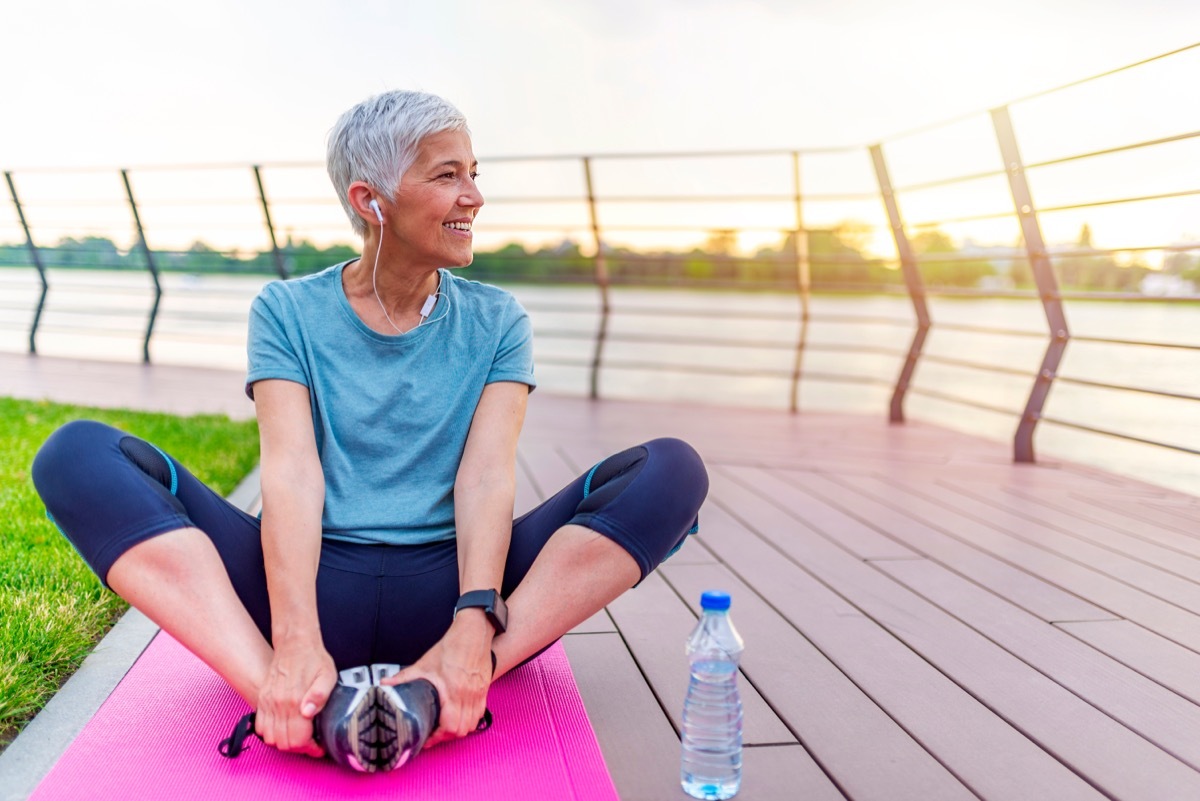 mature woman stretching before a jog