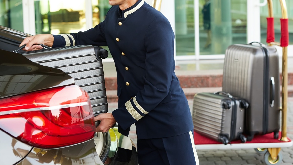 bellman loading car with luggages