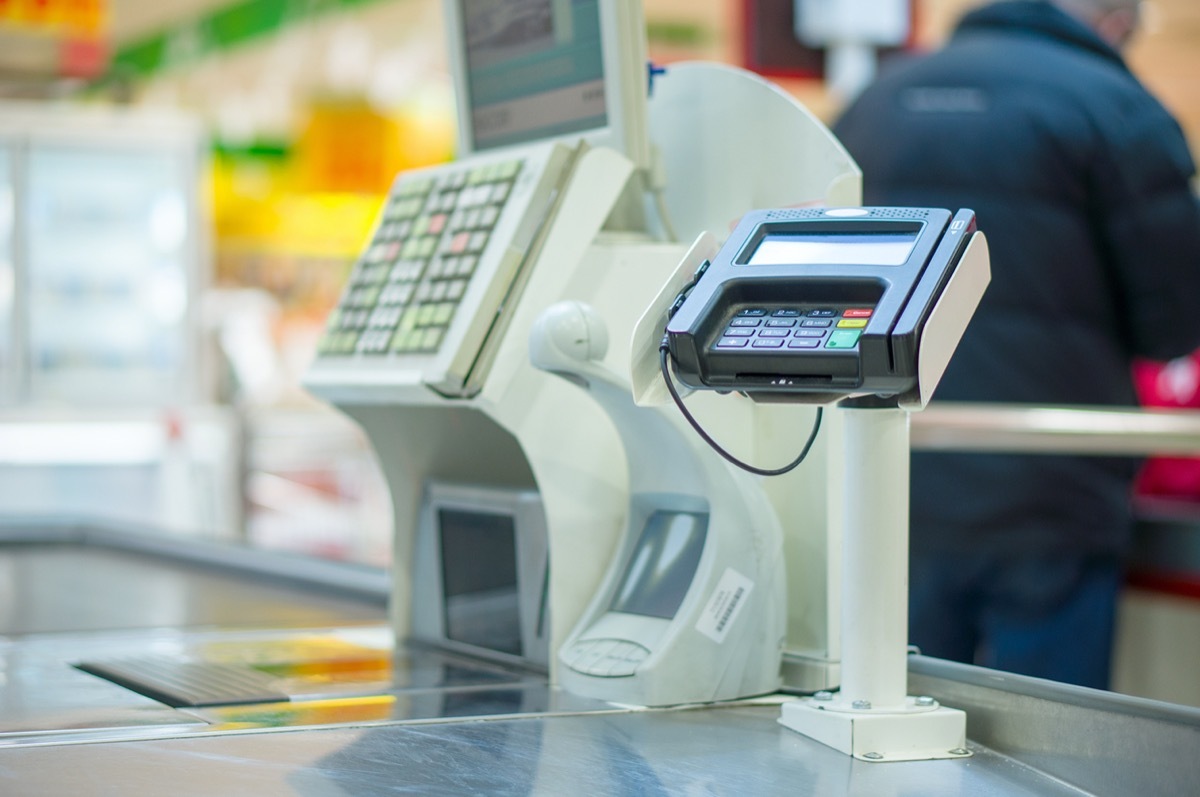 Empty cash desk with terminal in supermarket