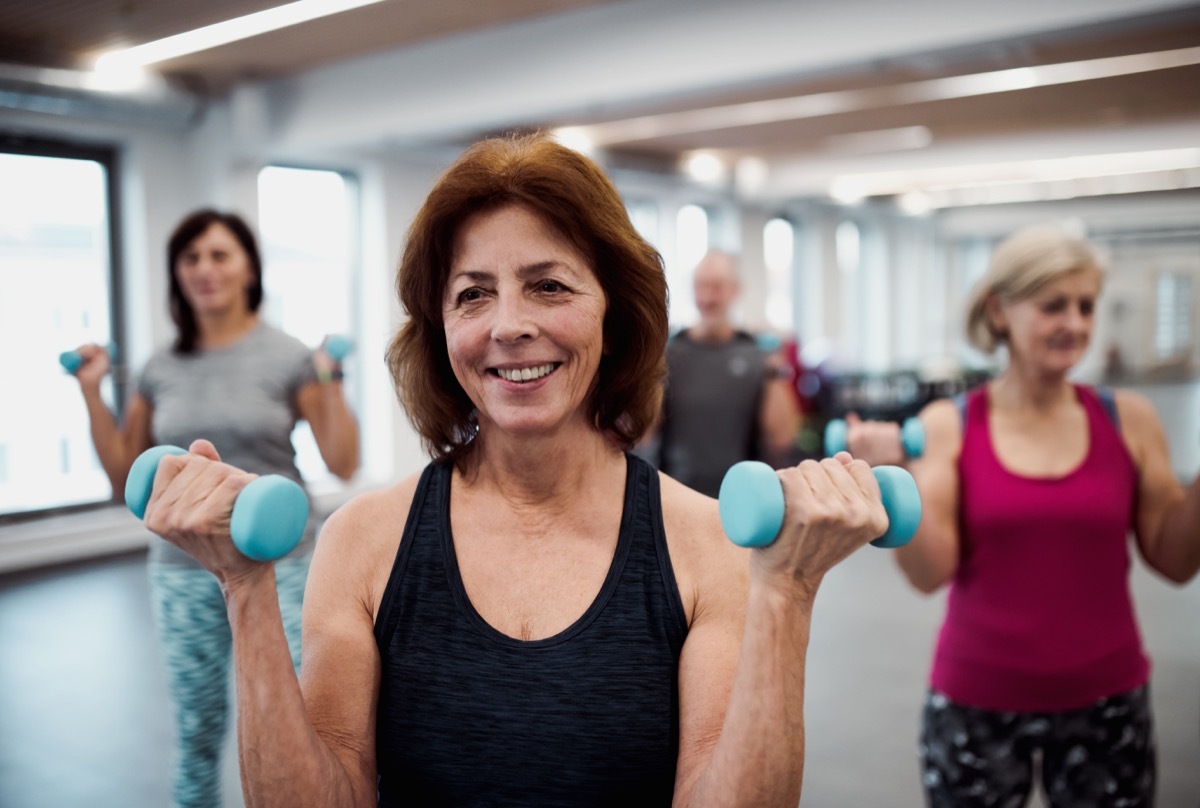 Older gym class lifting weights